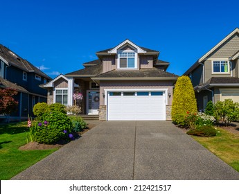 Double Doors Garage With Wide Long Driveway.