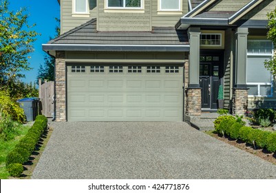 Double Doors Garage With Wide Long Driveway.