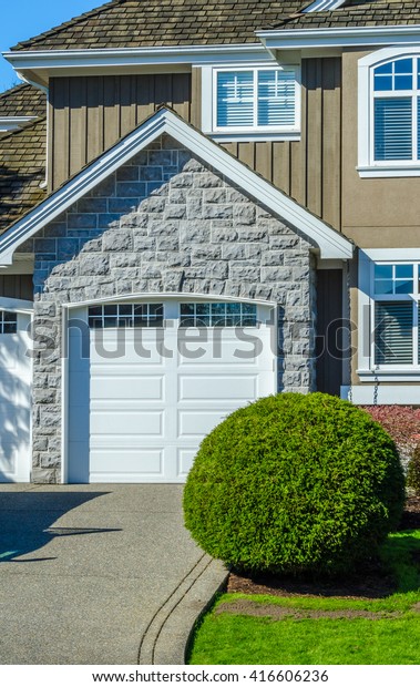 Double doors\
garage with wide, long\
driveway.