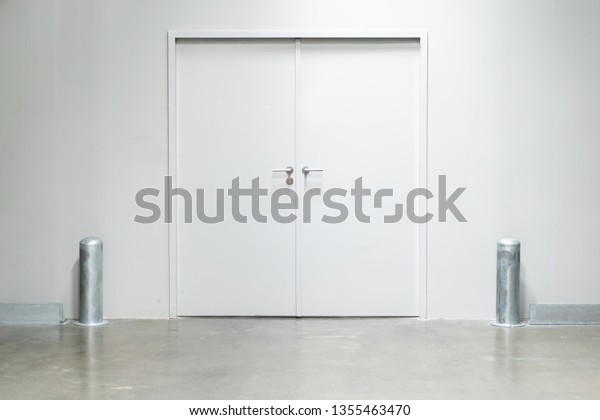 Double\
doors with security lock  in warehouse close\
up.
