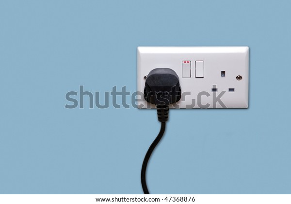 Double electrical power socket and single\
plug switched on, blue\
background.