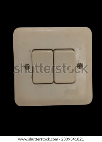 Double electrical wall switch isolated on black background. Two gang light switch for home electricity, interior installation, electrical maintenance, repair, and modern household concepts.