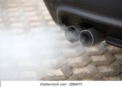 Double Exhaust Pipe Of A Car - Blowing Out The Pollution.