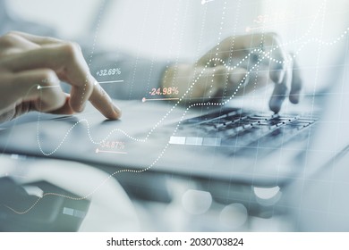 Double exposure of abstract creative statistics data hologram with hands typing on laptop on background, statistics and analytics concept