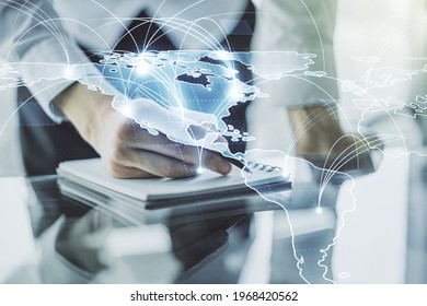Double exposure of abstract digital world map with connections and man hand writing in notepad on background, big data and blockchain concept - Shutterstock ID 1968420562