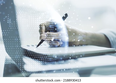 Double Exposure Of Abstract Digital World Map And Hand Writing In Notebook On Background With Laptop, Research And Strategy Concept