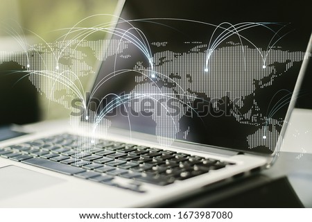 Double exposure of abstract digital world map with connections on laptop background, research and strategy concept