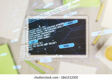 Double exposure of abstract programming language hologram and digital tablet on background, top view, research and development concept