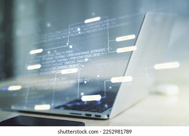 Double exposure of abstract programming language on laptop background, research and development concept