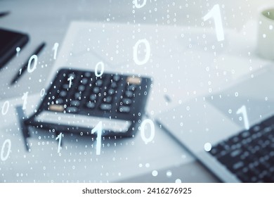 Double exposure of abstract virtual binary code hologram on blurry calculator with laptop background. Database and programming concept