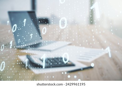 Double exposure of abstract virtual binary code hologram on blurry calculator with laptop background. Database and programming concept