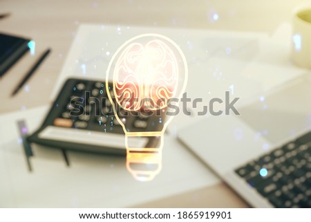 Double exposure of abstract virtual creative light bulb hologram with human brain on blurry calculator with laptop background, idea and brainstorming concept