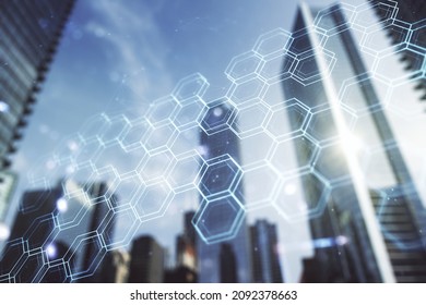 Double exposure of abstract virtual technology hologram with hexagon on modern skyscrapers background. Research and development software concept