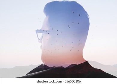 Double Exposure Back View Portrait Of A Man Combinated With Beautiful Landscape With Birds And Mountains On The Sunset. Freedom And Love Of Nature Concept