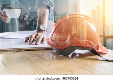 Double exposure of Building constructure and Image of engineer holding a cup of coffee and check blue print. selective focus