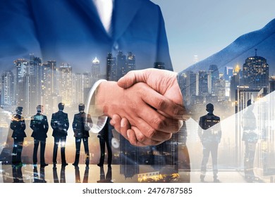 Double exposure of business handshake for successful of investment deal and city night background, teamwork and partnership concept.