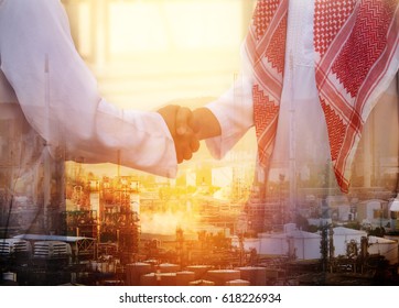 Double exposure of business handsome Arab man hand shake and Oil refinery background - Powered by Shutterstock