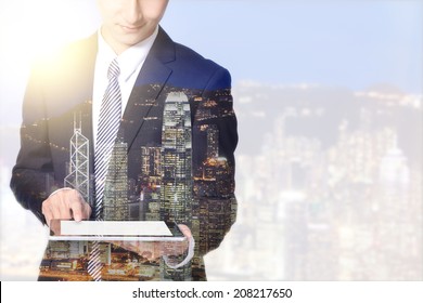 Double Exposure Business Man And City - Business Man Using Digital Tablet With City Night Skyline, Asia, China, Hong Kong