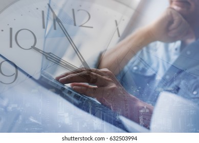 Double Exposure Of Business Man Working On Laptop Computer And Wall Clock And Cityscape. Freelancer Try To Finish  His Work On Time