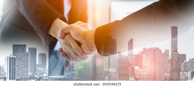 Double exposure Business people of Marketing team with a Partnership greeting power tag team,Teamwork Join Hands Partnership Concept after complete deal,Successful Teamwork Partnership in the city.