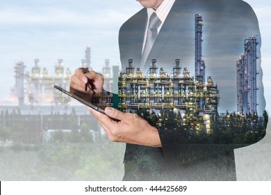 Double Exposure Of Businessman Hand Hold Tablet And Gas Refinery Industry Factory At Twilight Time As Energy Research And Development Concept.