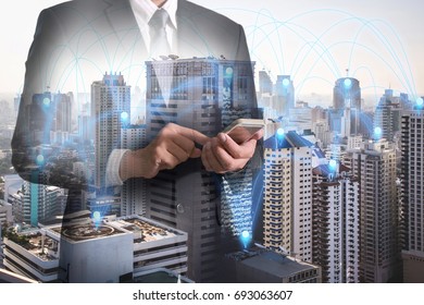 Double exposure of businessman hand hold and touch screen smartphone, mobile, pin node networking with cityscape as business, technology, telecommunication, communication and innovation concept.