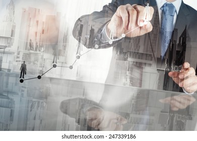 Double exposure of businessman hand working with new modern computer and business strategy as concept