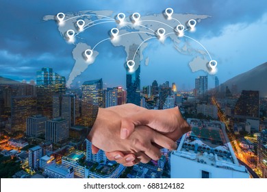 Double Exposure Of A Businessman Handshake With World Global Cartography Globalization And Map Pin Flat Network Conection Concept On Bangkok Cityscape In Business District At Night Background