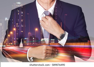 Double Exposure Of Businessman Held Necktie Dress To Look Good, Light Trails On Street, Urban And City In The Night As Get Ready Of Business Concept.