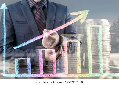 Double exposure of Businessman man with stack of money coins and growth graph, city night background. Money saving and investment concept.