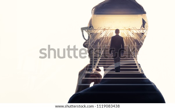 Double exposure of a businessman and stairs.\
Success of business\
concept.