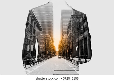 Double Exposure Of Businessman In Suit And Cityscape. He's Looking For His Success In Business And Idea For Life