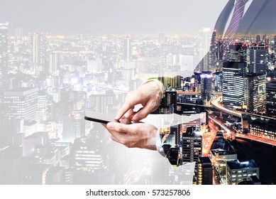 Double Exposure Businessman Touching On Smartphone Screen With City Overlay