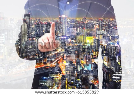 Double exposure businessman use finger touching on screen with connected city overlay 