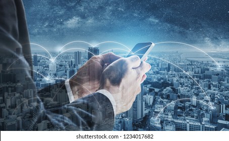 Double exposure businessman using mobile smart phone, and network connection technology in the city. Business network, blockchain technology and internet connection