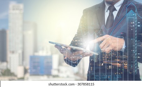 Double exposure of businessman using the tablet with cityscape and financial graph on blurred building background, Business Trading concept - Powered by Shutterstock