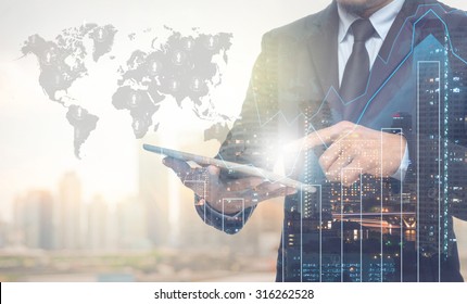 Double exposure of businessman using the tablet with cityscape and financial graph on blurred building with world map and people logo background, Elements of this image furnished by NASA - Powered by Shutterstock