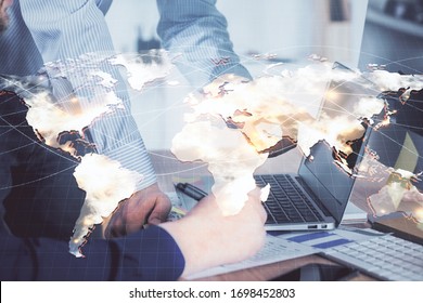 Double exposure of businessman working on laptop on background. International business hologram in front. Concept of success. - Shutterstock ID 1698452803