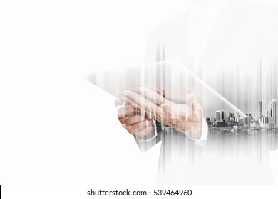 Double exposure businessman working on digital tablet with modern buildings in the city, isolated on white background - Shutterstock ID 539464960