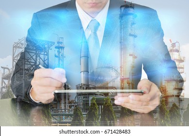 Double Exposure Of Businessman Working With Tablet, Digital Light Networking World Map, Electric Generating, Fuel Oil Factory And Energy Industry Plant At Sunset As Business And Industrial Concept.