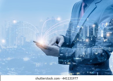 double exposure of businessmen using smart phone with blur city night and network connection concept - Powered by Shutterstock