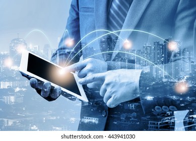 double exposure of businessmen using tablet with blur city night and network connection concept  - Shutterstock ID 443941030