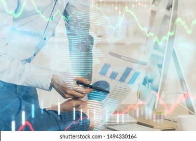 Double exposure of chart with businessman typing on computer in office on background. Concept of hard work. - Shutterstock ID 1494330164