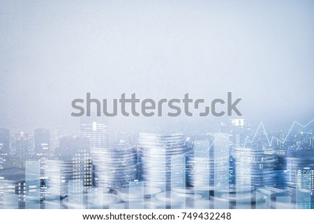 Double exposure of city, graph, rows of coins and blank space for finance and business concept