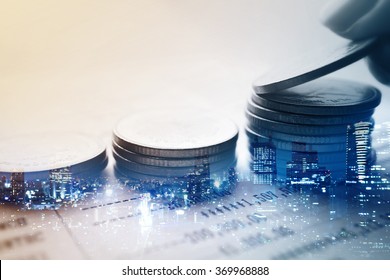 Double Exposure Of City And Rows Of Coins For Finance And Banking Concept