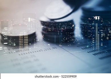 Double exposure of city and rows of coins for finance and banking concept