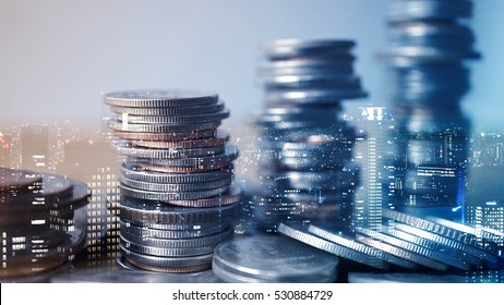Double exposure of city and rows of coins for finance and business concept - Shutterstock ID 530884729