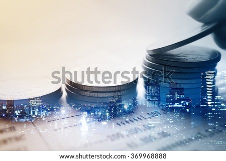 Double exposure of city and rows of coins for finance and banking concept