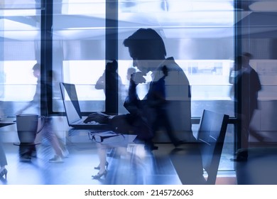 Double Exposure Concept Of Businessman Focused Working At Office Desk In A Busy City Environment. Fast Pace Work Rush. 