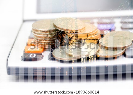 Double exposure of construction and graph on rows of coins for finance and businessconcept
